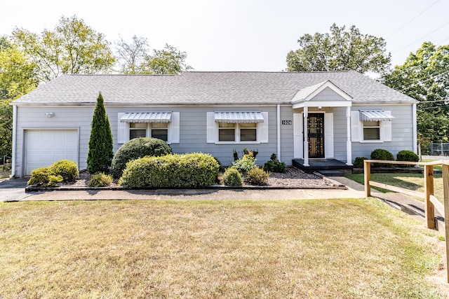 single story home featuring a garage and a front yard