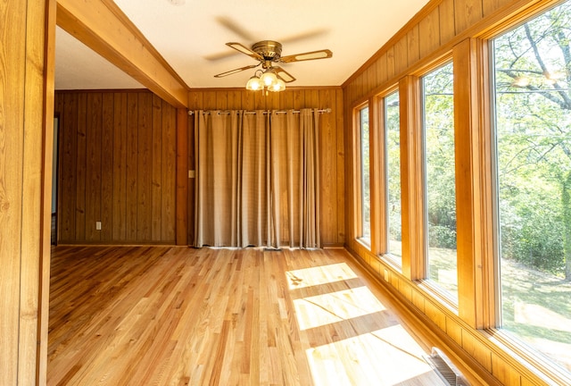 unfurnished sunroom featuring ceiling fan