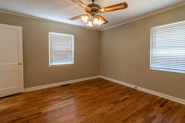 spare room featuring a textured ceiling, crown molding, dark wood-type flooring, and ceiling fan