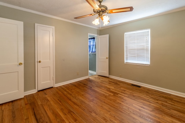 unfurnished room with ceiling fan, ornamental molding, and hardwood / wood-style floors