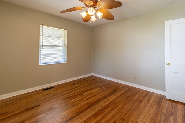 spare room with ceiling fan and hardwood / wood-style flooring