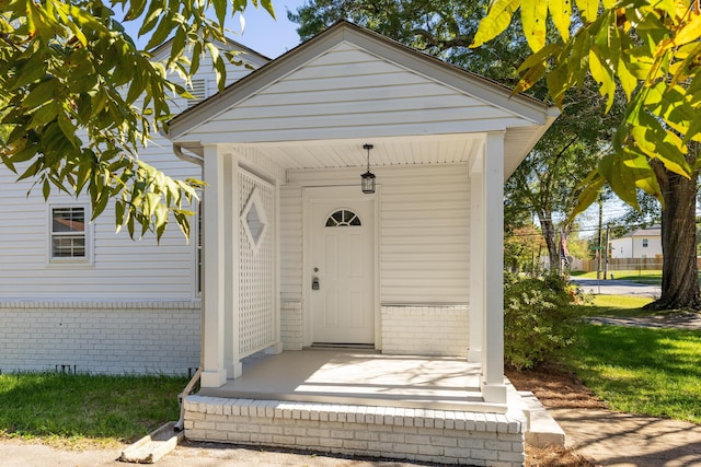 view of exterior entry featuring covered porch