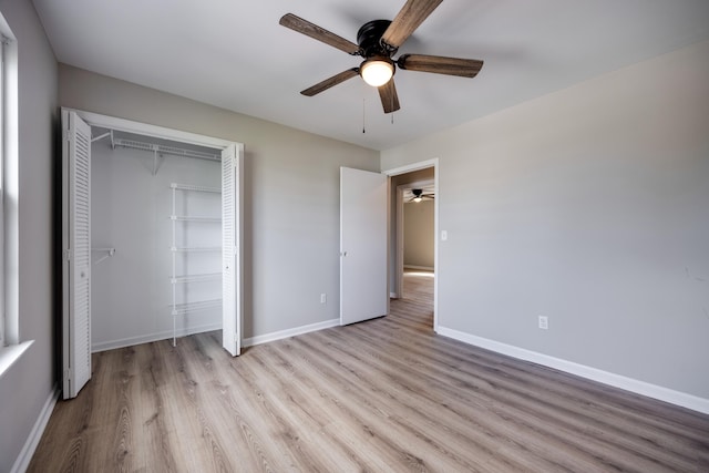 unfurnished bedroom with ceiling fan, a closet, and light hardwood / wood-style floors