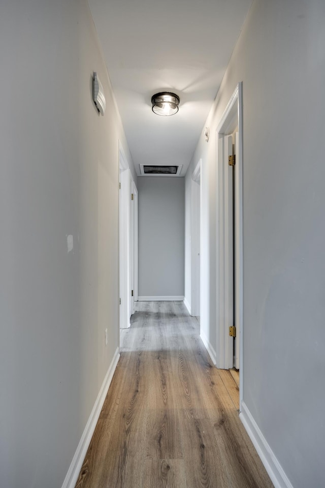 corridor with light hardwood / wood-style flooring