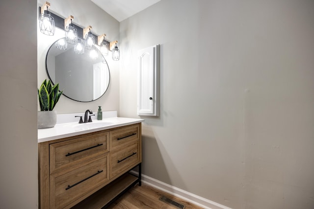 bathroom with hardwood / wood-style floors and vanity