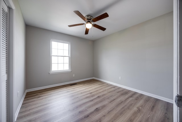 empty room featuring ceiling fan and light wood-type flooring