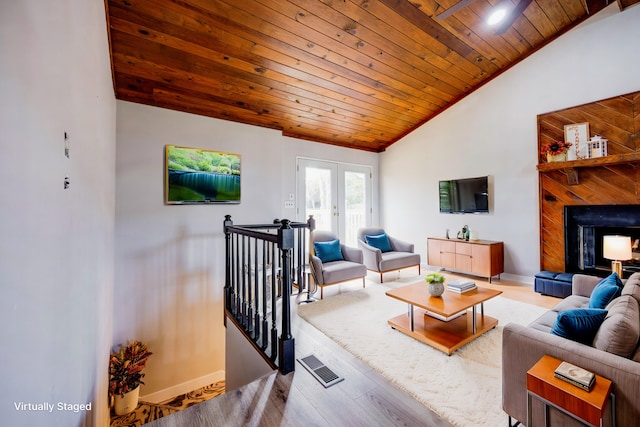 living room featuring light hardwood / wood-style floors, lofted ceiling, wood ceiling, and french doors