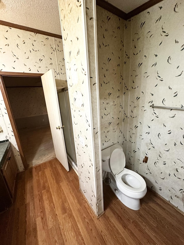 bathroom with toilet and hardwood / wood-style flooring