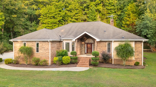 single story home featuring a front lawn