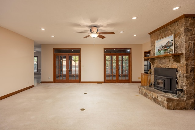 living room featuring french doors, light colored carpet, a textured ceiling, and ceiling fan