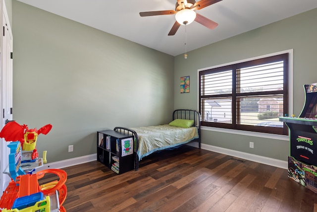 bedroom with ceiling fan and dark hardwood / wood-style floors