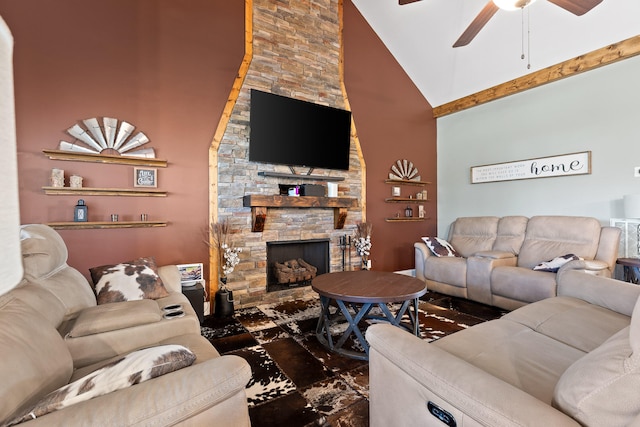 living room featuring ceiling fan, a fireplace, and high vaulted ceiling