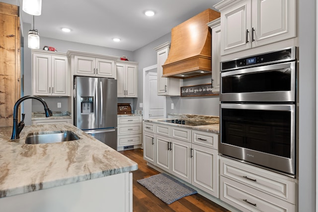 kitchen with sink, white cabinetry, custom range hood, appliances with stainless steel finishes, and dark hardwood / wood-style flooring