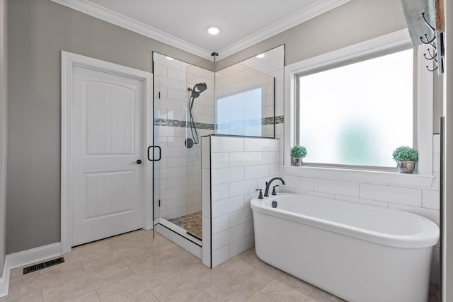 bathroom featuring independent shower and bath, crown molding, and tile patterned flooring