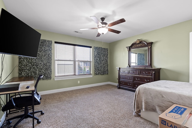 carpeted bedroom featuring ceiling fan and multiple windows