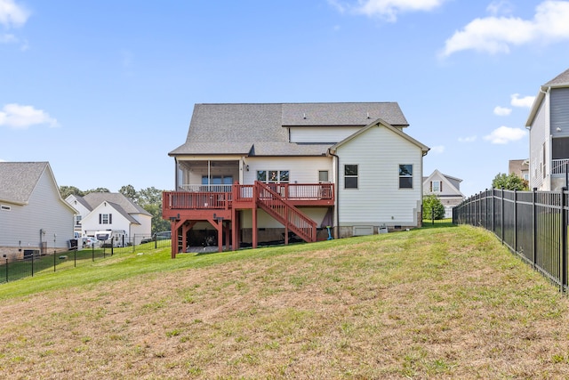 back of house featuring a wooden deck and a lawn