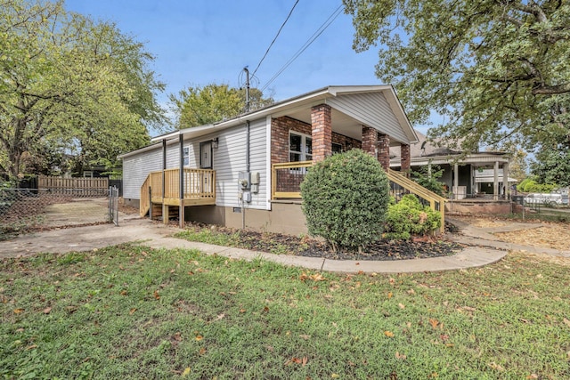 view of property exterior with a lawn and a deck