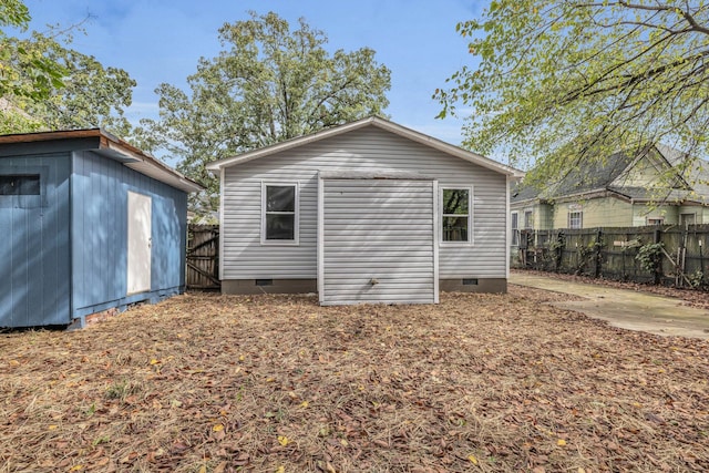 back of property featuring a storage shed