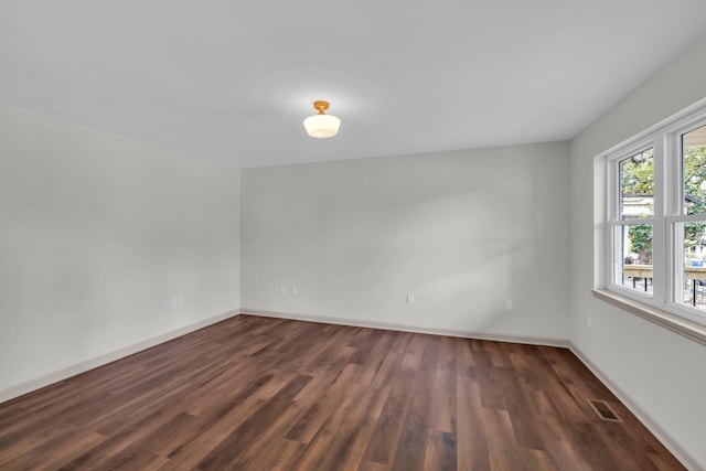 spare room featuring dark hardwood / wood-style flooring