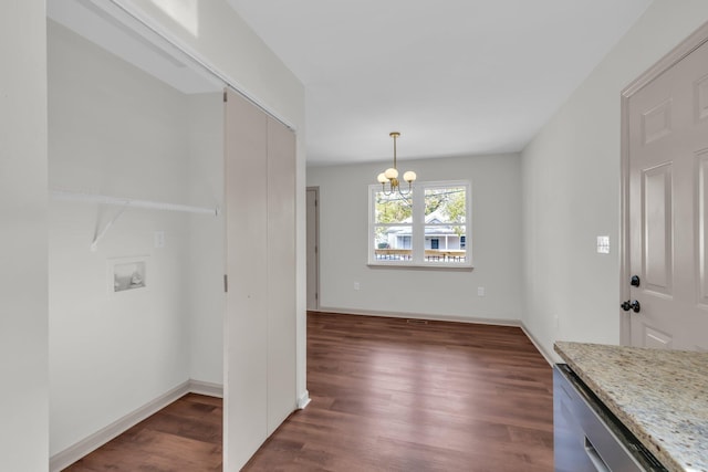 unfurnished dining area with an inviting chandelier and dark hardwood / wood-style flooring