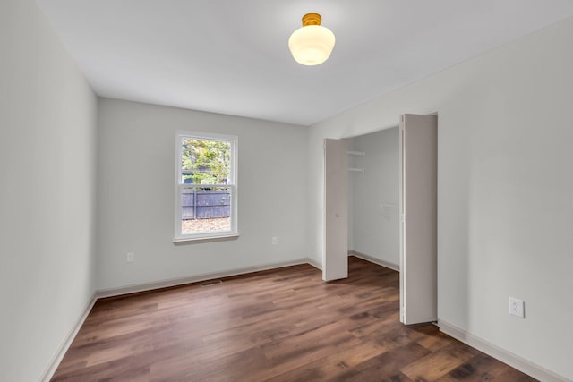 unfurnished bedroom featuring dark wood-type flooring