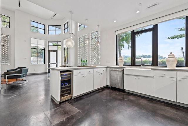 kitchen featuring white cabinetry, plenty of natural light, and beverage cooler