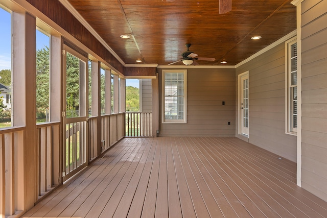 unfurnished sunroom with ceiling fan and wooden ceiling