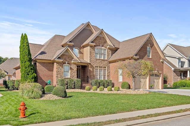 view of front of property featuring a front yard and a garage