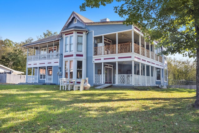 back of property featuring a lawn and a balcony