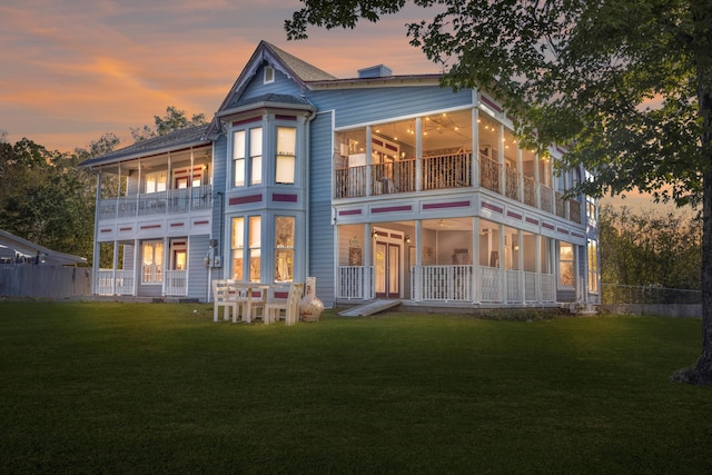 back house at dusk with a yard