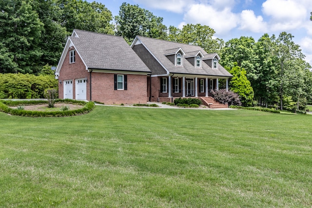 cape cod house with a front lawn, covered porch, and a garage