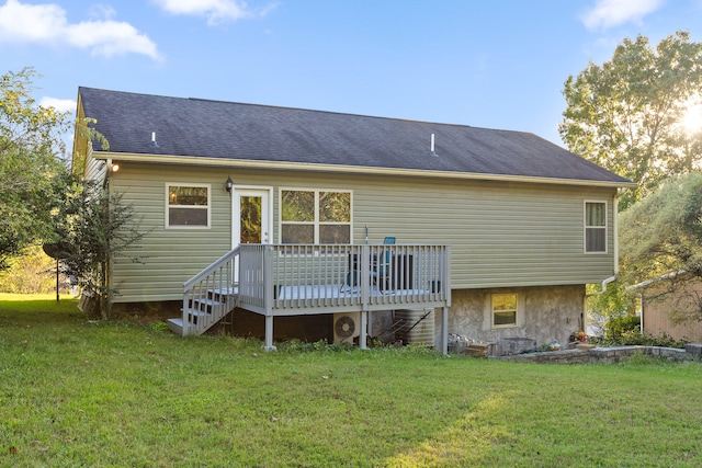 back of house featuring a wooden deck and a yard