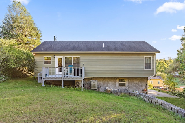 back of property with a lawn, cooling unit, and a deck