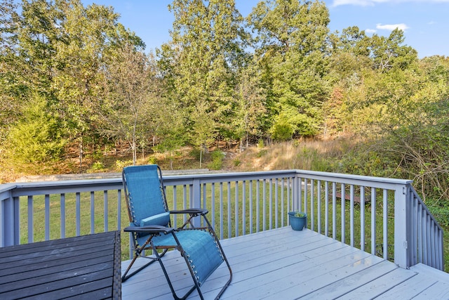 wooden terrace featuring a yard