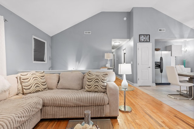 tiled living room with high vaulted ceiling