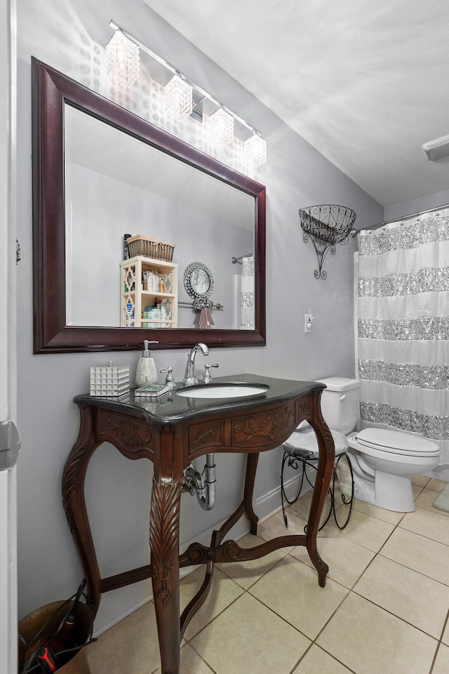 bathroom with sink, tile patterned flooring, and toilet