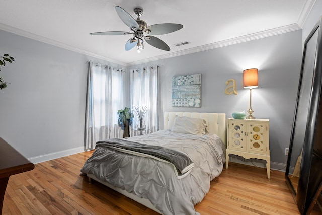 bedroom featuring wood-type flooring, ceiling fan, and crown molding