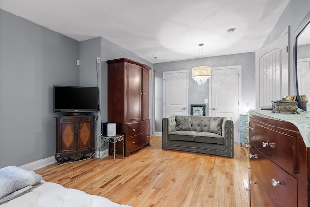 interior space featuring an inviting chandelier and light wood-type flooring