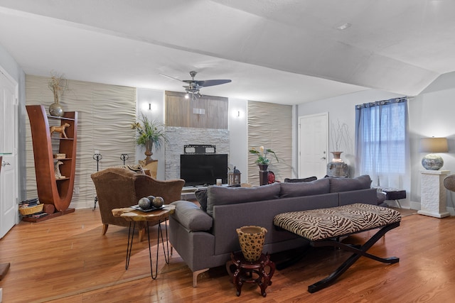 living room featuring wood-type flooring and ceiling fan