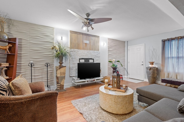 living room featuring ceiling fan and hardwood / wood-style floors