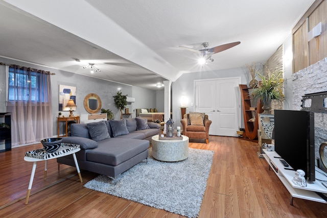 living room featuring ceiling fan, light hardwood / wood-style flooring, and ornate columns