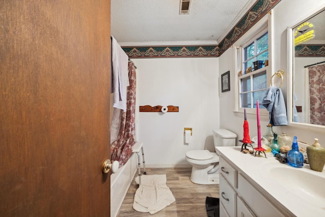 full bathroom with vanity, toilet, ornamental molding, shower / bath combo with shower curtain, and hardwood / wood-style floors