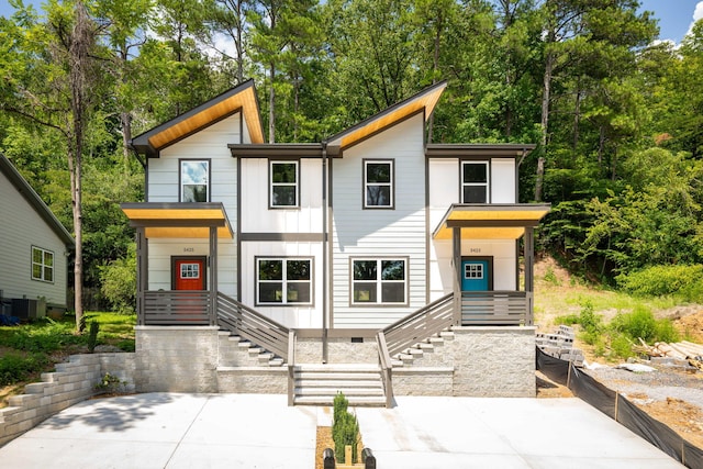 modern home with a porch and cooling unit