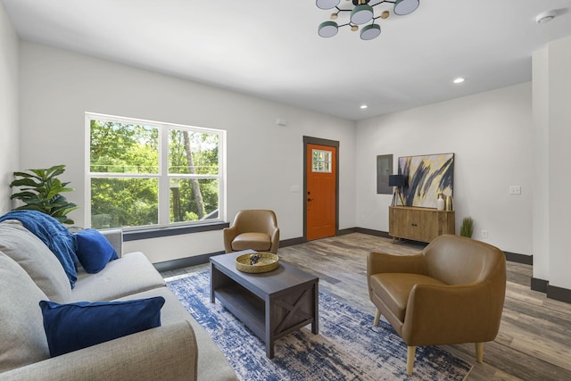 living room with a notable chandelier and wood-type flooring