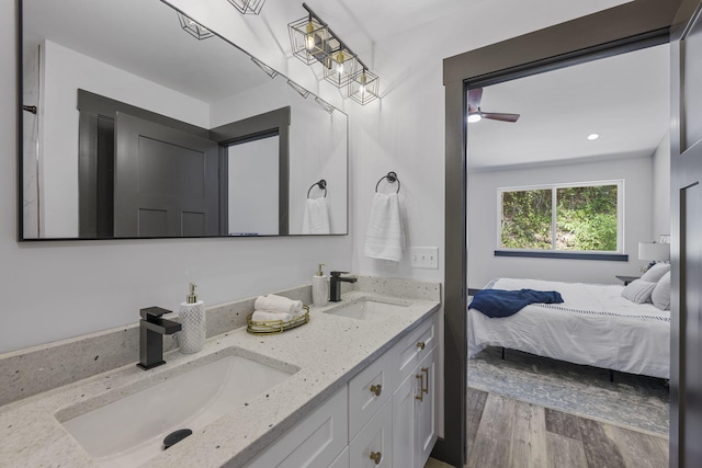 bathroom with vanity, hardwood / wood-style flooring, and ceiling fan