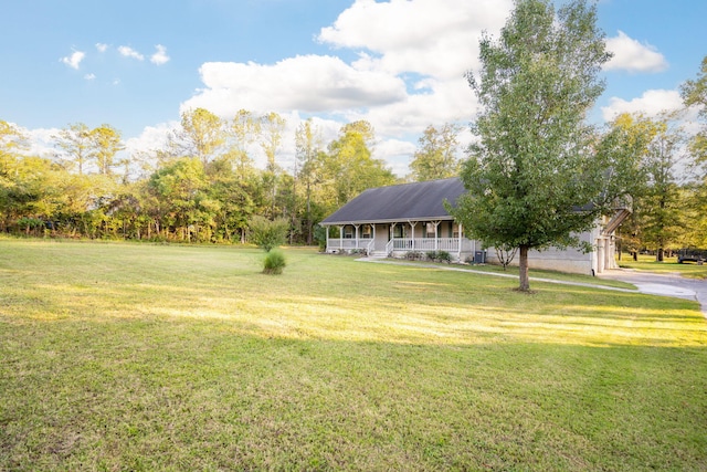 view of yard featuring covered porch