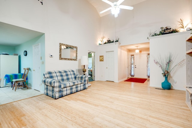 living room featuring ceiling fan, high vaulted ceiling, and wood-type flooring