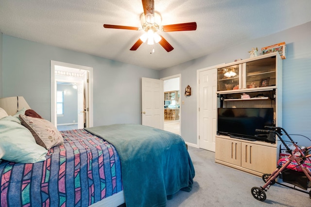 carpeted bedroom with a textured ceiling and ceiling fan