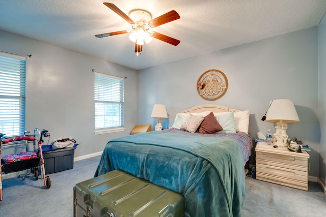 bedroom featuring carpet, multiple windows, and ceiling fan