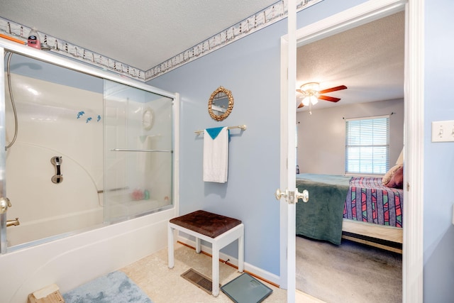 bathroom with ceiling fan, a textured ceiling, and bath / shower combo with glass door